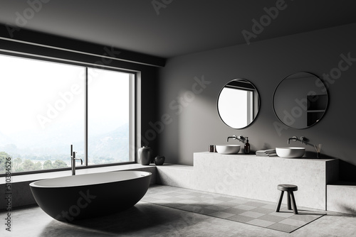 Grey bathroom interior with bathtub and sink, accessories and panoramic window