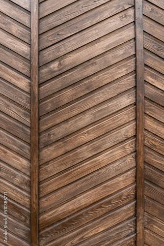 Old wooden planks in the form of a herringbone pattern. Close-up. Background. Texture.