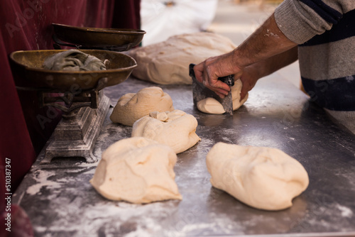 male hands knead yeast dough for baking bread