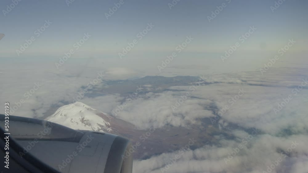 Aerial view from plane, propeller, clouds and mountains