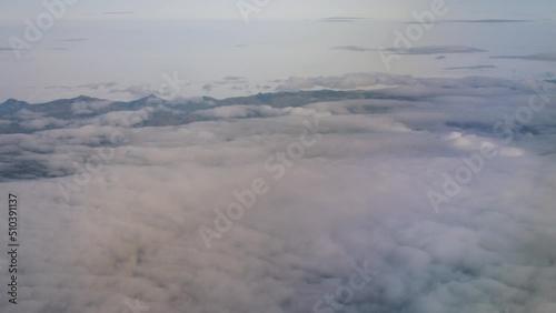 Aerial view from plane, clouds and mountains