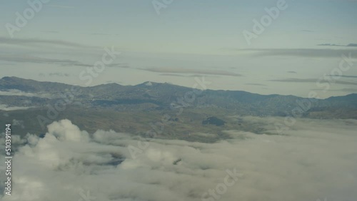 Aerial view from plane, clouds and mountains