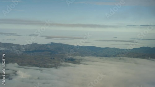 Aerial view from plane, clouds and mountains