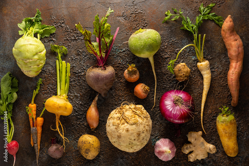 Assortment of Vegetables and root vegetables on textured background. Autumn harvest. Healthy food and vegetarian concept. photo