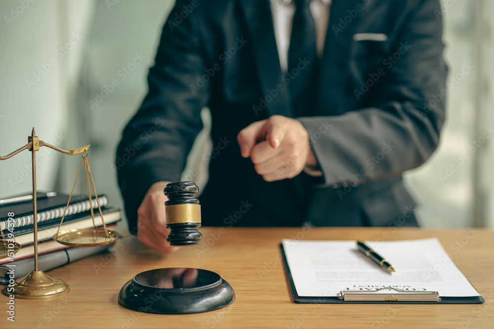 Business lawyers work hard at their desks with books and papers. The judge uses a hammer at the justice attorney. Lawyer's Office The goddess of justice and the scales of the law. advice Business lawyers work hard at their desks with books and papers. The judge uses a hammer at the justice attorney. Lawyer's Office The goddess of justice and the scales of the law. advice