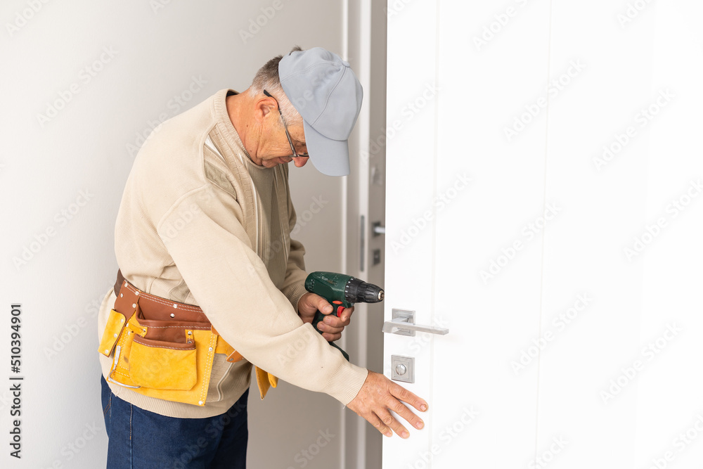 Worker man installs plastic windows white lock and seal adjustment.