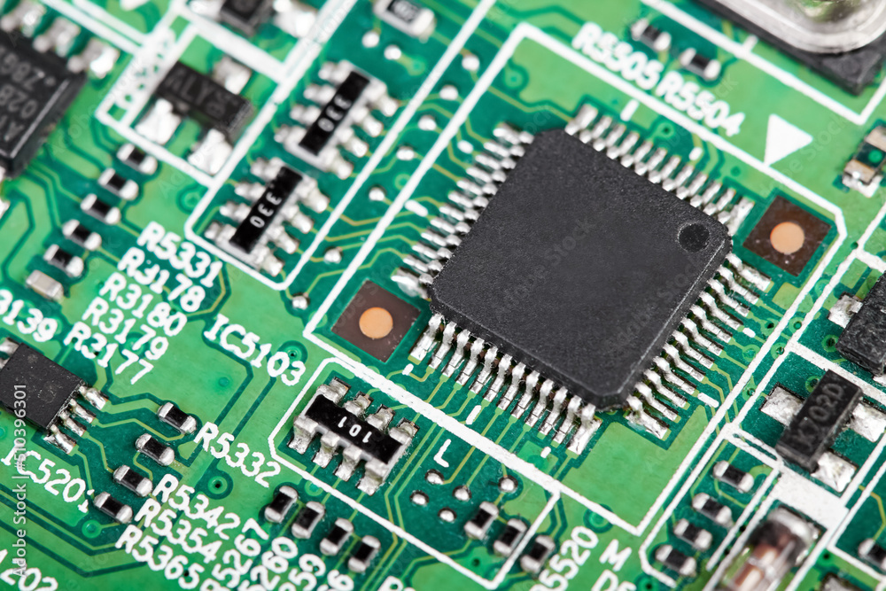 Close-up of a green computer printed circuit board with selective focus on a chip Close-up of a green computer printed circuit board with selective focus on a chip