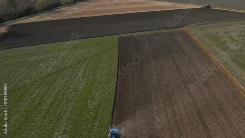Aerial view of a tractor plowing a field in Lomellina, Po Valley, Italy. photo