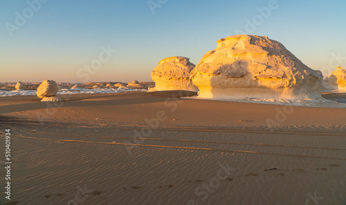 Sunset in the white desert in Egypt  with amazing white rock formations and the sun setting