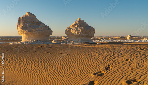 Sunset in the white desert in Egypt, with amazing white rock formations and the sun setting
