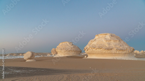 Sunset in the white desert in Egypt, with amazing white rock formations and the sun setting