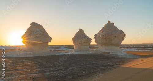 Sunset in the white desert in Egypt, with amazing white rock formations and the sun setting
