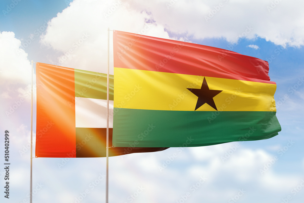 Sunny blue sky and flags of ghana and uae Sunny blue sky and flags of ghana and uae