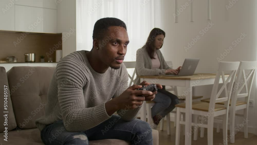 A young couple arguing about console gaming at home