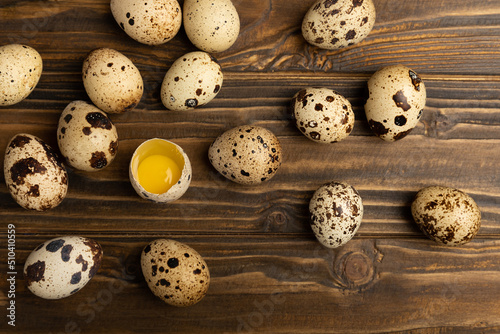 Quail eggs on a brown texture background.Organic food. Place for text. Fresh quail eggs.