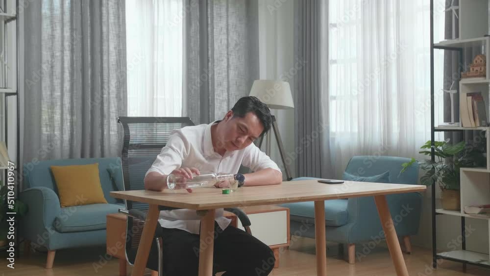 Drunk, Depressed Asian Man With Smartphone On Table Pouring Vodka In A Shot Glass Before Drinking At The Home
Drunk, Depressed Asian Man With Smartphone On Table Pouring Vodka In A Shot Glass Before Drinking At The Home