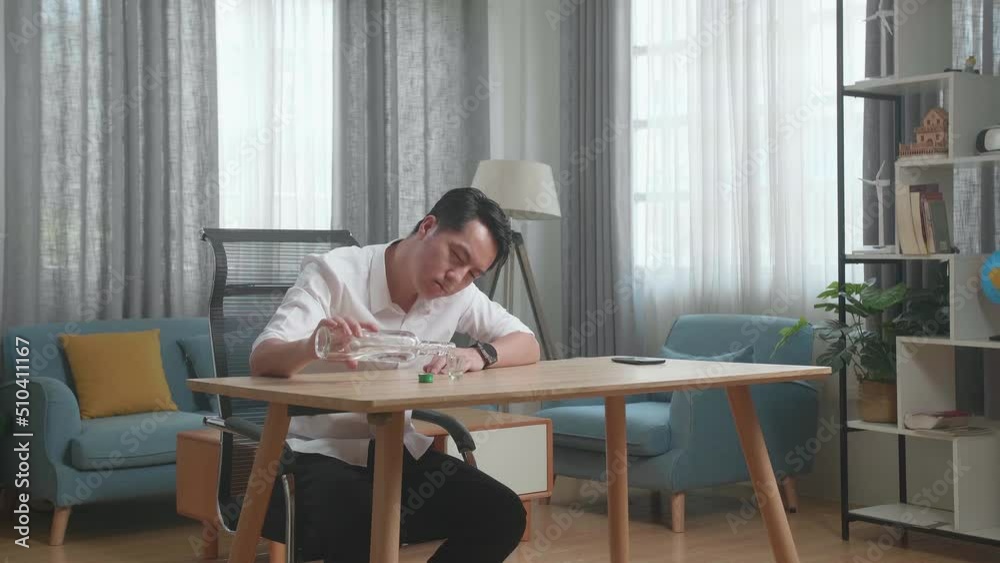 Drunk, Depressed Asian Man With Smartphone On Table Pouring Vodka In A Shot Glass Before Drinking At The Home
Drunk, Depressed Asian Man With Smartphone On Table Pouring Vodka In A Shot Glass Before Drinking At The Home