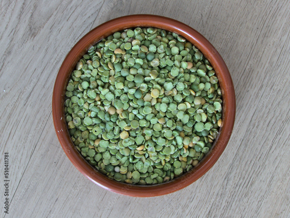 Split pea close-up in a clay dish - Texture background - Food Split pea close-up in a clay dish - Texture background - Food