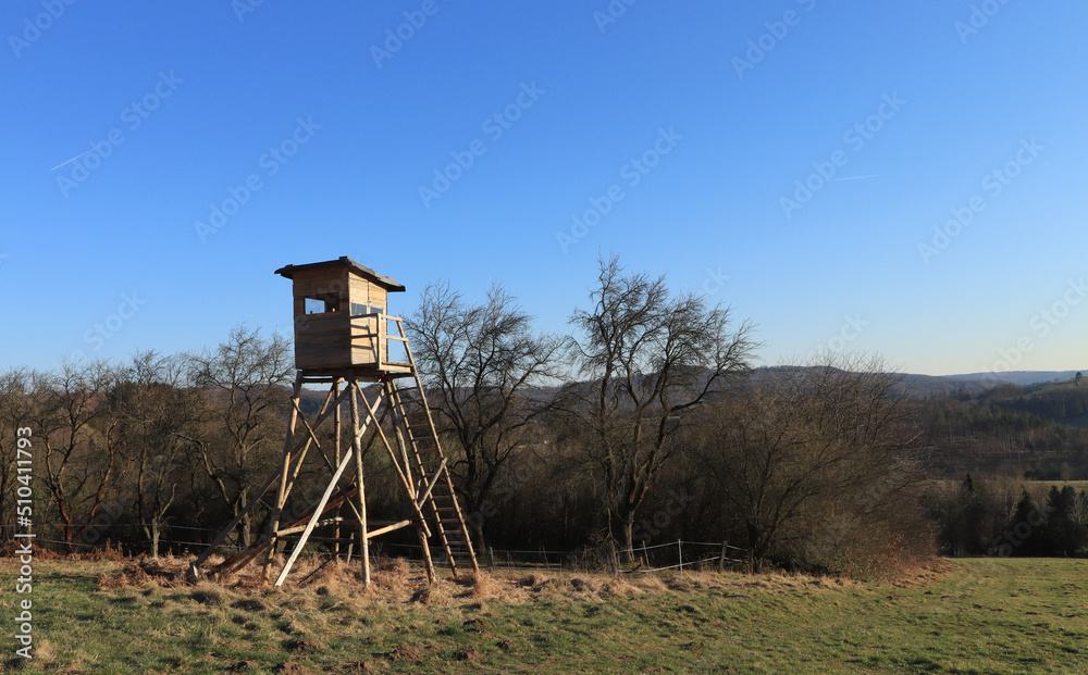 Wooden hunting pulpit standing on the edge of the grassland Wooden hunting pulpit standing on the edge of the grassland