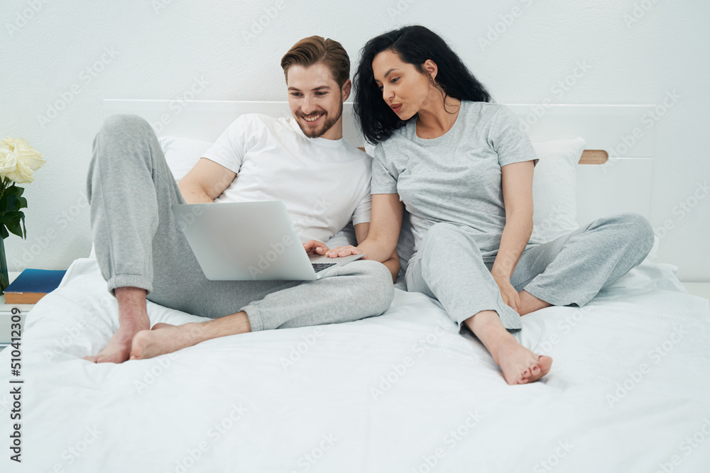 Young couple watching something on portable computer