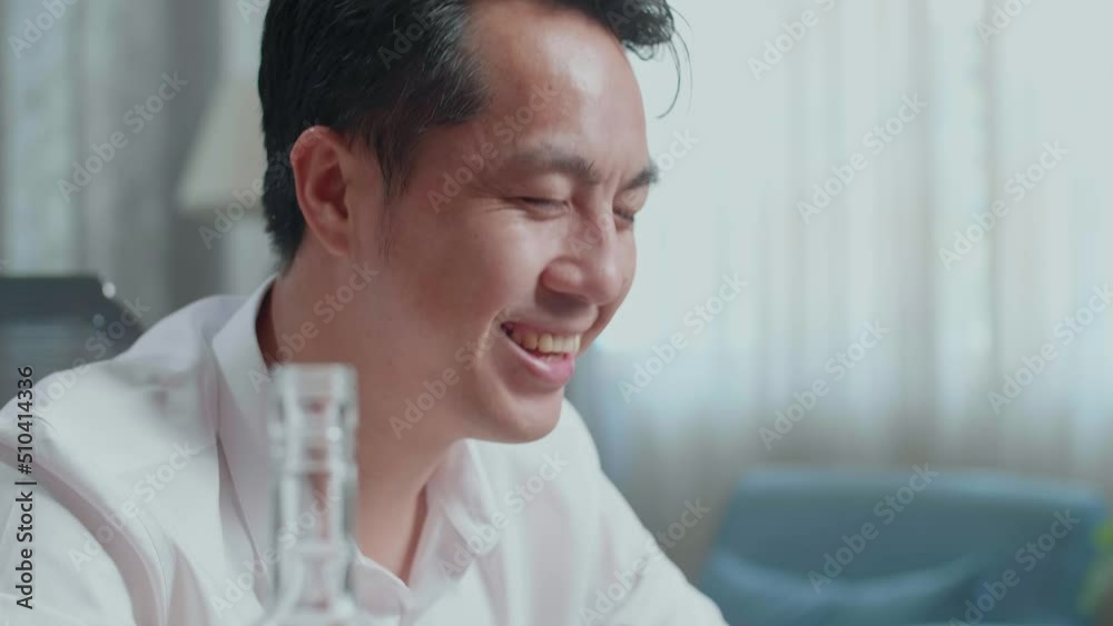 Close Up Of Asian Man Pouring Vodka In A Shot Glass Before Cheering And Drinking While Having Video Call On Laptop At Home
Close Up Of Asian Man Pouring Vodka In A Shot Glass Before Cheering And Drinking While Having Video Call On Laptop At Home
