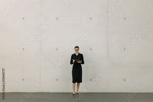 Business woman using tablet pc in minimalist office interior © 4Max