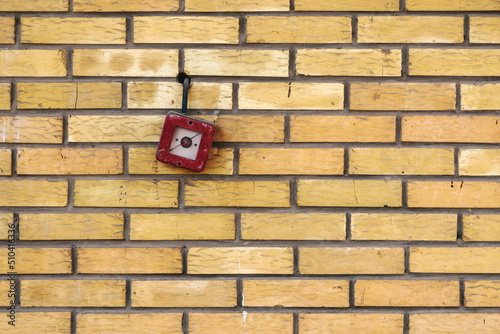 Vintage fire alarm box mounted on the brick wall