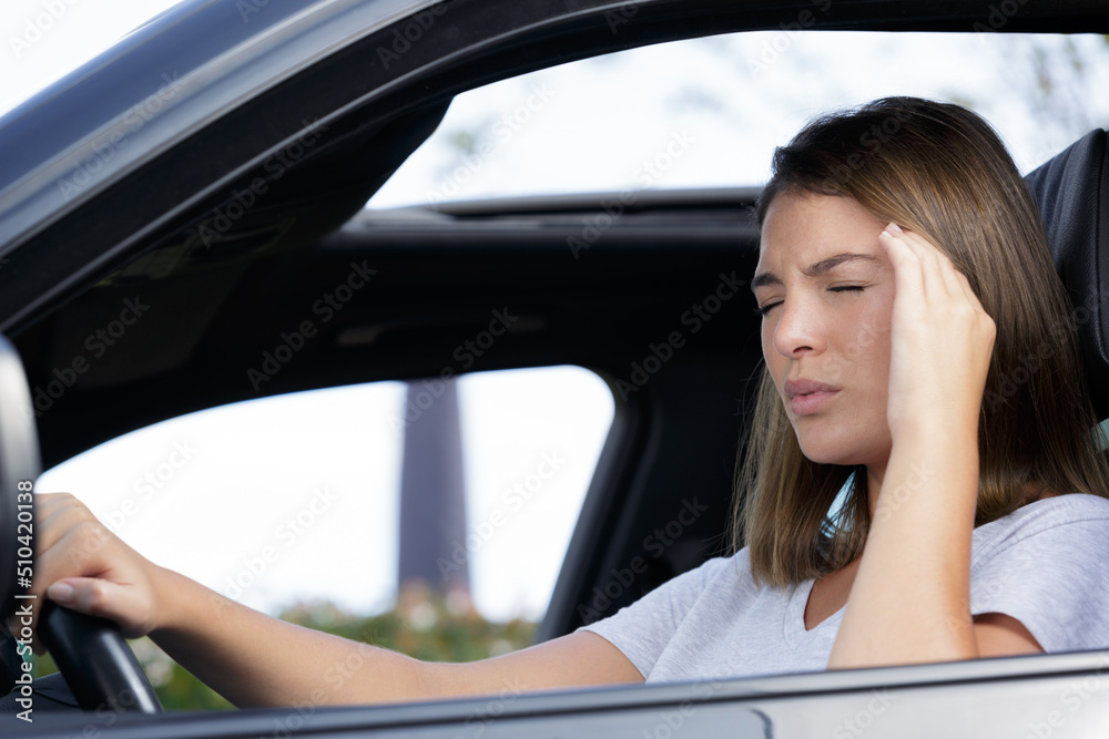 female driver suffering with a headache