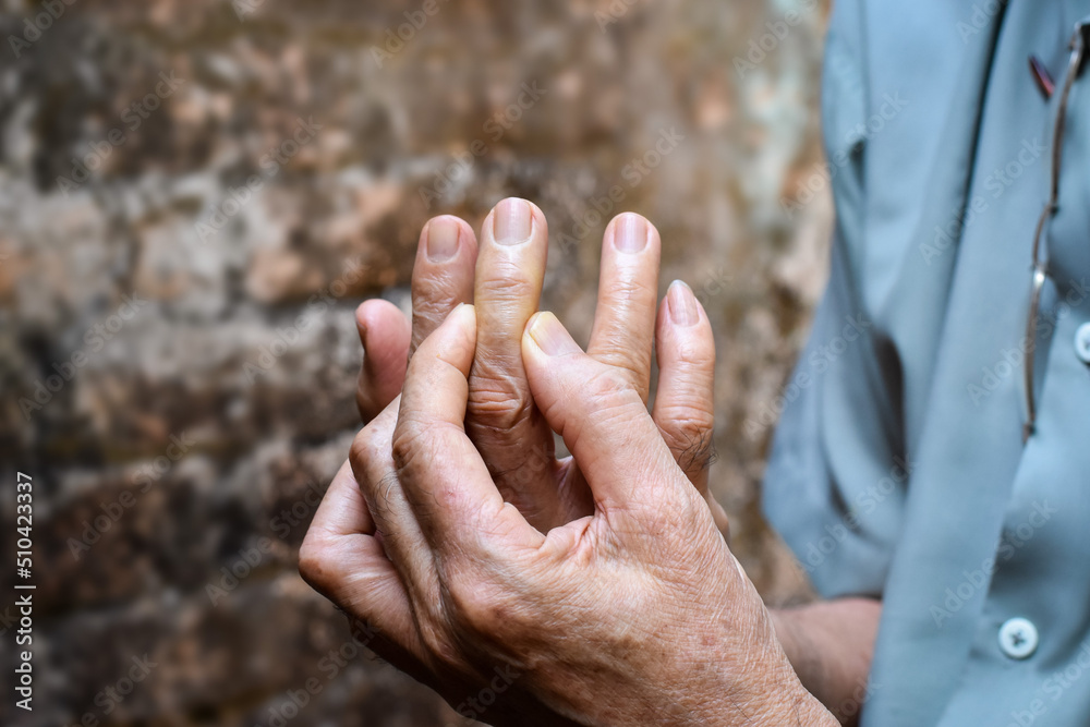 Middle finger pain in Asian man. Concept of cellulitis and finger problems. Middle finger pain in Asian man. Concept of cellulitis and finger problems.