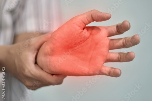 Painful palm of Asian man. Concept of compartment syndrome, cellulitis and hand muscles pain. photo