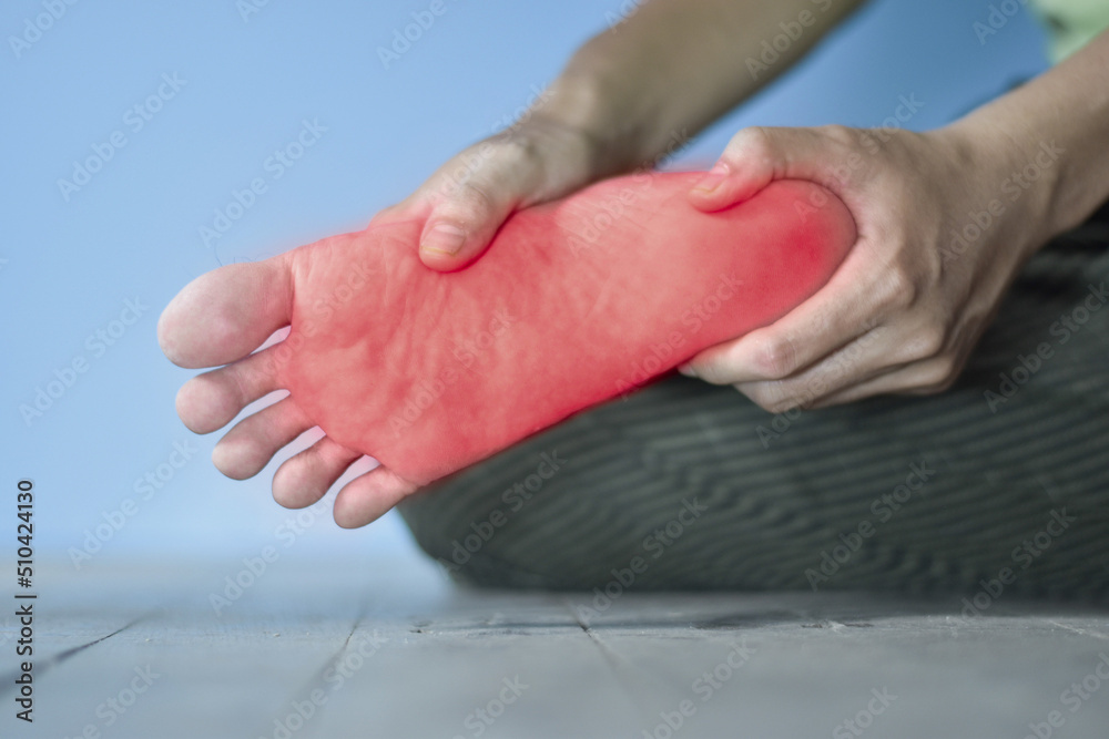 Tingling and burning sensation in foot of Asian man. Foot pain. Sensory