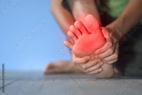 Tingling and burning sensation in foot of Asian man. Toes pain. Sensory neuropathy problems. Foot nerves problems. Plantar fasciitis.