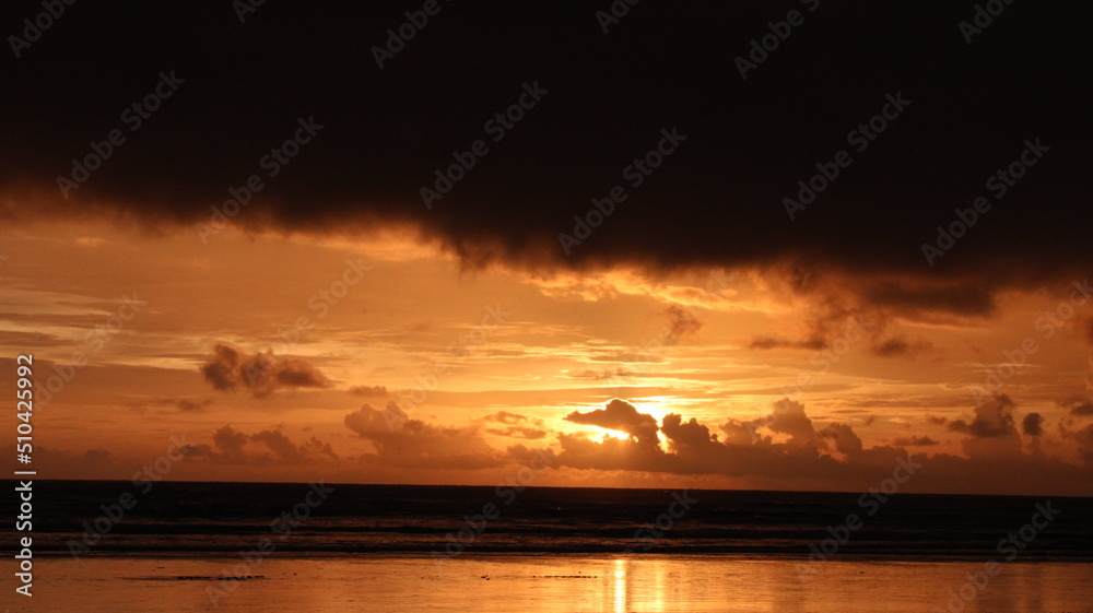 cloud over the sun, sunset over the sea cloud over the sun, sunset over the sea