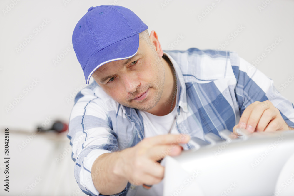repairman working on an electrical appliance repairman working on an electrical appliance