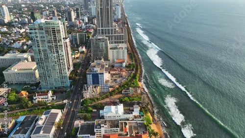 Aerial Tilt Up Shot Of Residential City By Sea Coastline, Drone Flying Backwards Over Hotel Rooftop - Colombo, Sri Lanka