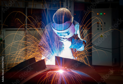 The welder is welding steel plates