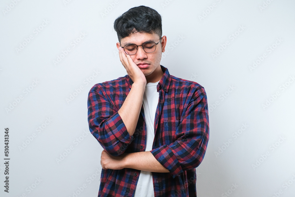 Young asian man thinking looking tired and bored with depression problems with crossed arms. Young asian man thinking looking tired and bored with depression problems with crossed arms.
