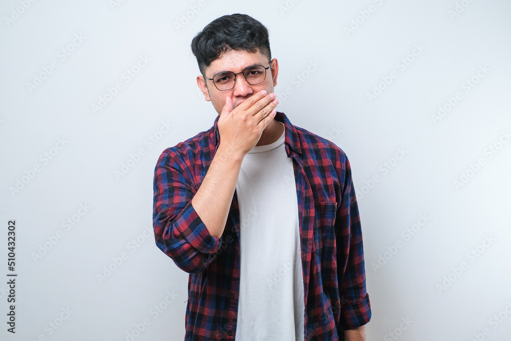 Young asian man smelling something stinky and disgusting, intolerable smell, holding breath with fingers on nose. Bad smell Young asian man smelling something stinky and disgusting, intolerable smell, holding breath with fingers on nose. Bad smell