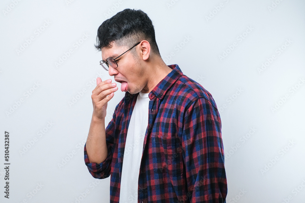 Young asian man smelling something stinky and disgusting, intolerable smell, holding breath with fingers on nose. Bad smell Young asian man smelling something stinky and disgusting, intolerable smell, holding breath with fingers on nose. Bad smell