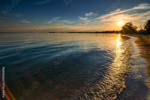 Scenery from the beautiful sandy setting of the Big Sandy Bay beach on Wolfe Island in Frontenac County near Kingston Ontario Canada. Windmills and beautiful water landscapes.