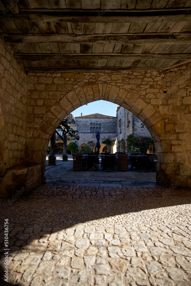 Old stone arch in the bastide of Monpazier in Dordogne