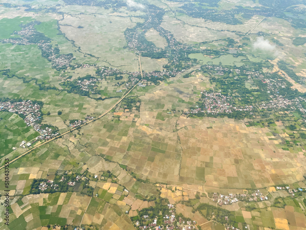 The aerial landscape shows a green view of the city. Streets, rice fields, and village houses.
