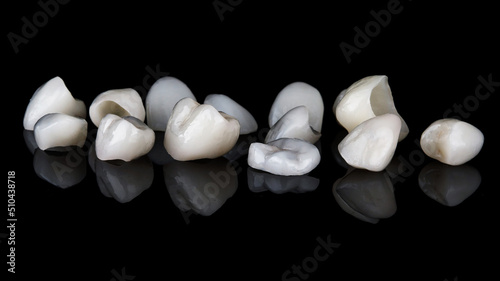 excellent composition of different ceramic dental veneers on black glass with creative reflections