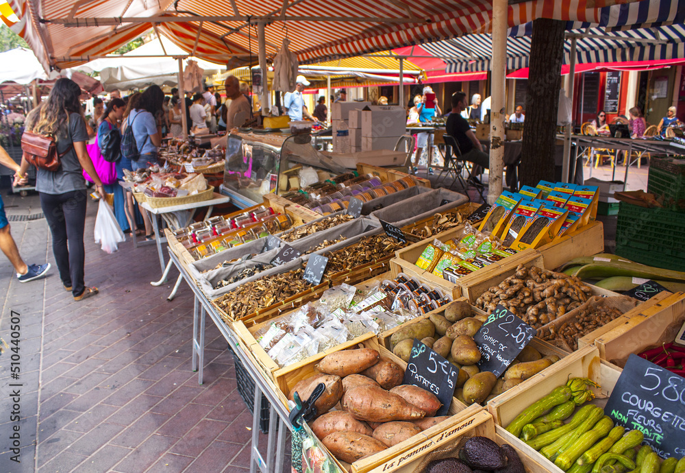Various vegetables and fruit are laid out on counters of the well-known Cours Saleya market