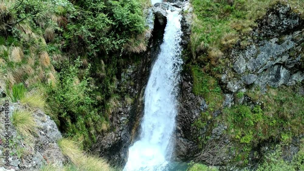 Tilt of 3 sucessive waterfalls. Green flora on the two sides with some rocks. Shot in valley Tilt of 3 sucessive waterfalls. Green flora on the two sides with some rocks. Shot in valley