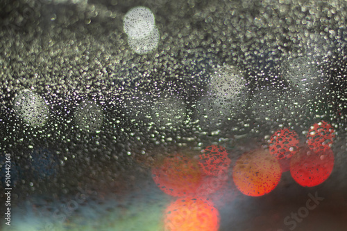 Fototapeta Naklejka Na Ścianę i Meble -  Blurred background with raindrops and lights.