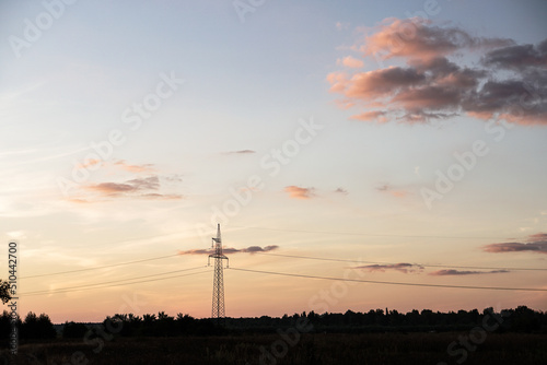High voltage power line at dusk. Green energy with renewable resources. © subjob
