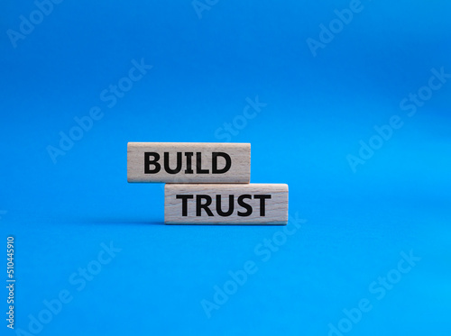 Build trust symbol. Wooden blocks with words Build trust. Beautiful blue background. Business and Build trust concept. Copy space.