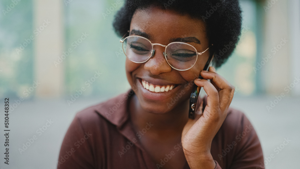 Pretty dark-skinned female in glasses having conversation with f Pretty dark-skinned female in glasses having conversation with f