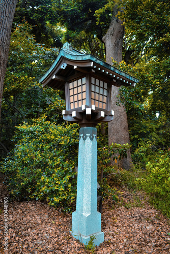 Traditional Japanese wooden lantern.Japanese style lampost on walking passage through the garden in Meiji-Jingu Shrine, Tokyo, Japan.